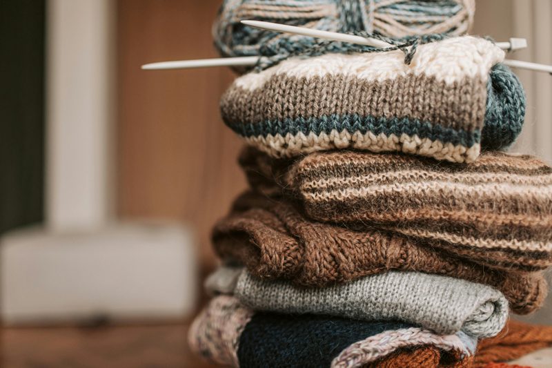 stack of hand knitted scarves