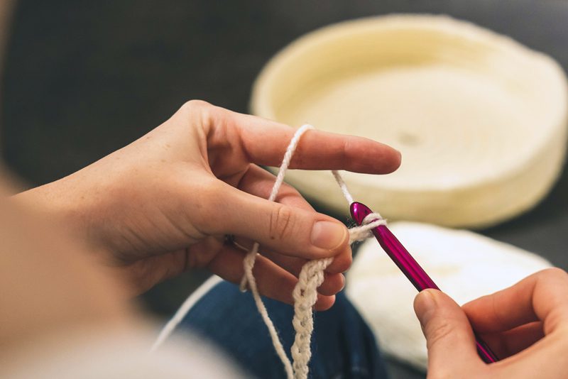 person crocheting