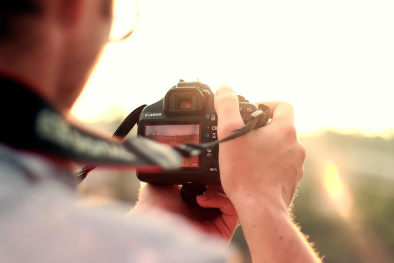 man holding a dslr camera