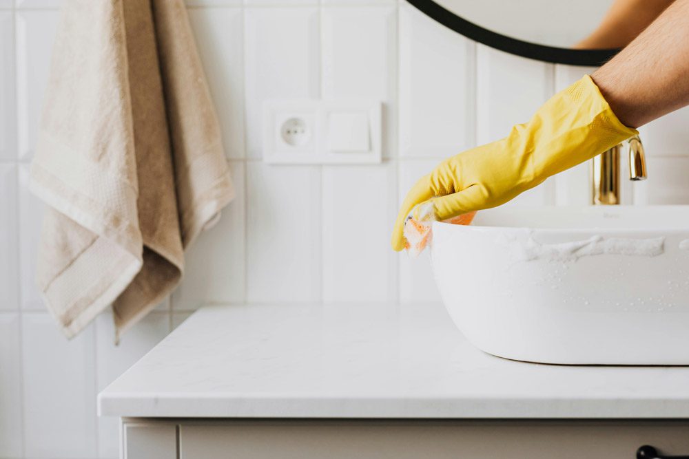 house cleaner scrubbing sink