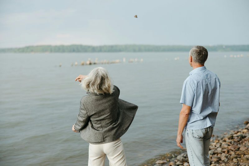 retired couple skipping stones