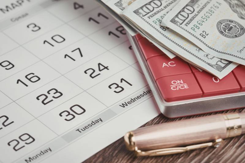 cash laying on top of calendar