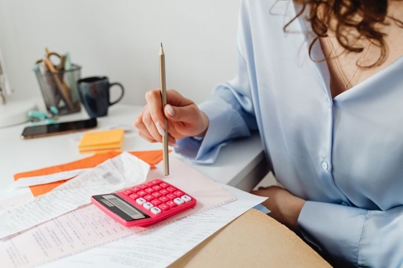 woman reviewing bills with calculator