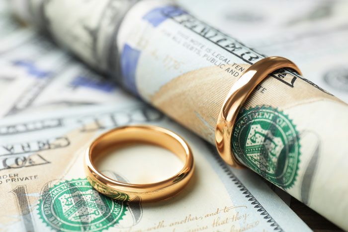 wedding bands sitting on cash