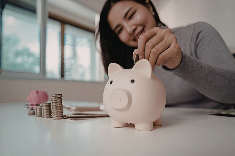 woman saving money in a piggy bank