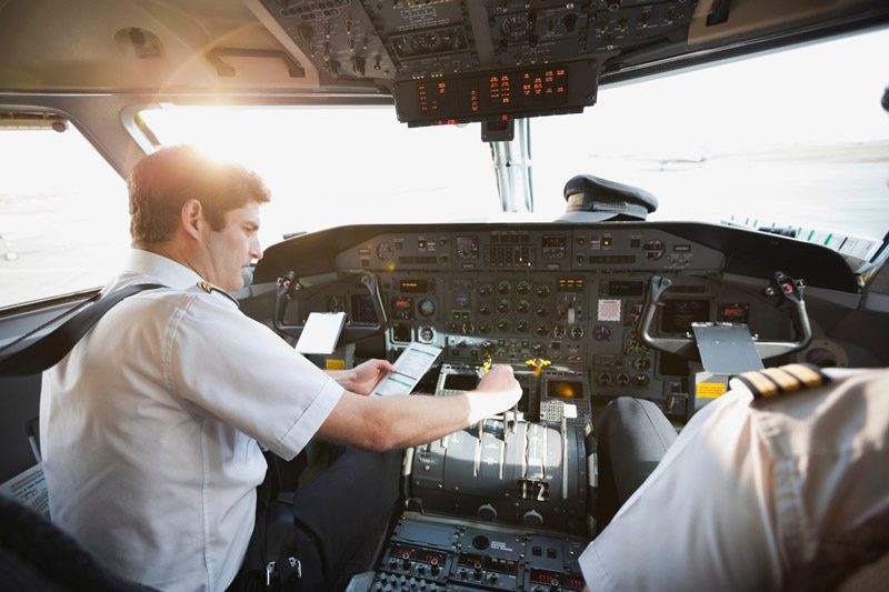 commercial pilots sitting in cockpit