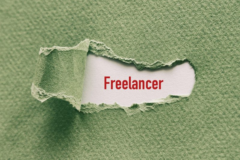 freelancer banner under torn green paper